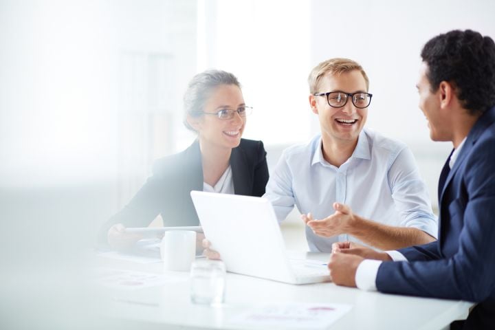 Three people holding a meeting with each other.