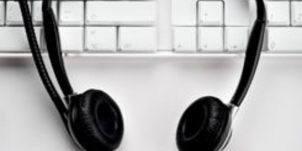 A headset that rests on a keyboard.